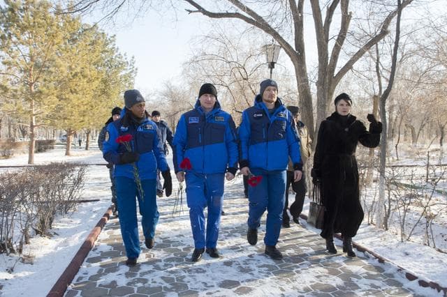 NASA image: jsc2017e136939 - At the Cosmonaut Hotel crew quarters in Baikonur, Kazakhstan, the Expedition 54-55 backup crewmembers take a stroll down the Walk of Cosmonauts Dec. 6 to lay flowers in traditional pre-launch ceremonies. From left to right are Jeanette Epp