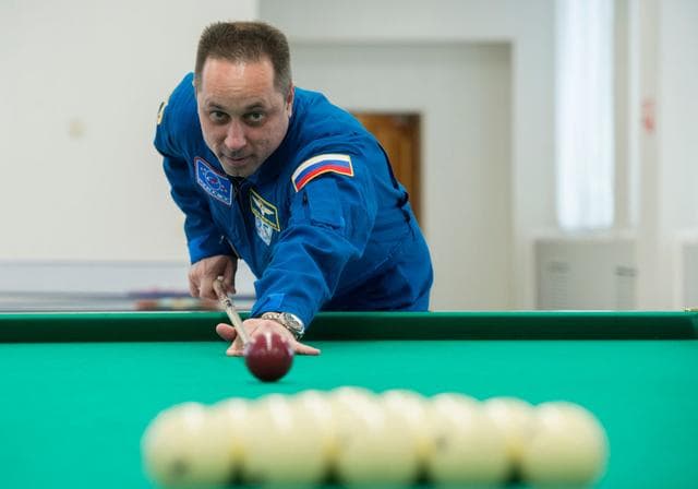 NASA image: jsc2017e137344 - At the Cosmonaut Hotel crew quarters in Baikonur, Kazakhstan, Expedition 54-55 prime crewmember Anton Shkaplerov of the Russian Federal Space Agency (Roscosmos) tries his hand at a game of billiards Dec. 11 during a break in pre-launch tr