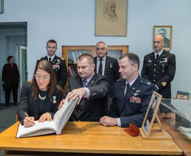 NASA image: jsc2019e004426 - At the Gagarin Museum in the Gagarin Cosmonaut Training Center in Star City, Russia, Expedition 59 crewmember Christina Koch of NASA (front, left) signs a ceremonial book Feb. 21 as part of the crewâ€™s pre-launch activities as her crewma