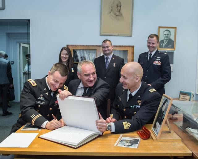 NASA image: jsc2019e004427 - At the Gagarin Museum in the Gagarin Cosmonaut Training Center in Star City, Russia, Expedition 59 backup crewmember Drew Morgan of NASA (front, left) signs a ceremonial book Feb. 21 as his crewmates, Alexander Skvortsov of Roscosmos (cen