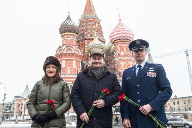 NASA image: jsc2019e004431 - With St. Basilâ€™s Cathedral in Red Square in Moscow providing a wintry backdrop, Expedition 59 crewmembers Christina Koch of NASA (left), Alexey Ovchinin of Roscosmos (center) and Nick Hague of NASA (right) pose for pictures Feb. 21 prio