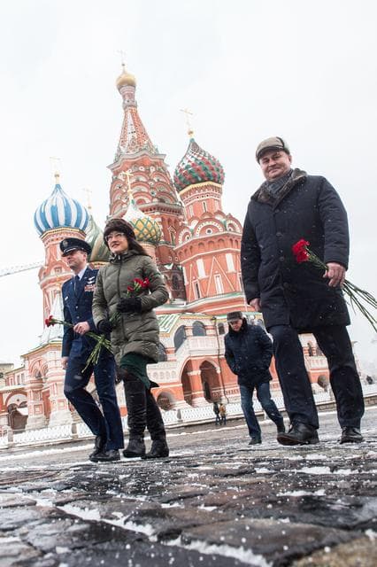 NASA image: jsc2019e004432 - With St. Basilâ€™s Cathedral in Red Square in Moscow providing a wintry backdrop, Expedition 59 crewmembers Nick Hague of NASA (left), Christina Koch of NASA (center) and Alexey Ovchinin of Roscosmos (right) walk toward the Kremlin Wall F