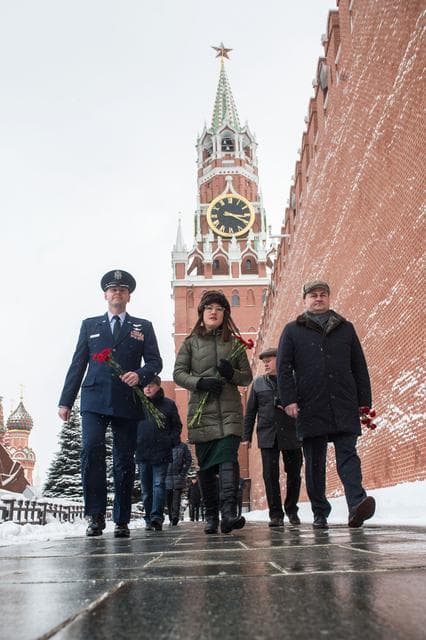 NASA image: jsc2019e004433 - Expedition 59 crewmembers Nick Hague of NASA (left), Christina Koch of NASA (center) and Alexey Ovchinin of Roscosmos (right) walk along the Kremlin Wall in Moscow Feb. 21 as they prepare for the ceremonial laying of flowers as part of pr