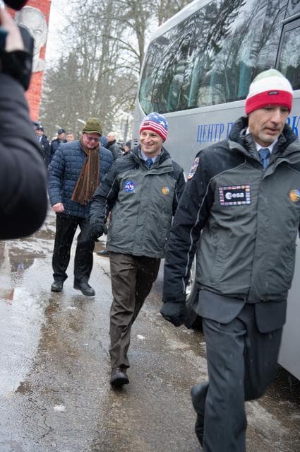 NASA image: At the Gagarin Cosmonaut Training Center in Star City, Russia, Expedition 59 backup crewmembers Drew Morgan of NASA (center) and Luca Parmitano of the European Space Agency (right) walk to a bus Feb. 26 to take them to their plane for a flight to the Baik