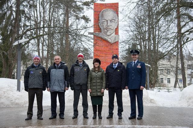 NASA image: At the Gagarin Cosmonaut Training Center in Star City, Russia, the Expedition 59 prime and backup crewmembers pose for pictures Feb. 26 in front of the statue of Vladimir Lenin as they prepared to depart for their launch site at the Baikonur Cosmodrome in