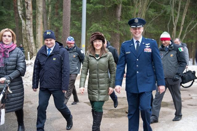 NASA image: At the Gagarin Cosmonaut Training Center in Star City, Russia, Expedition 59 crewmembers Alexey Ovchinin of Roscosmos (second from left), Christina Koch of NASA (second from right) and Nick Hague of NASA (right) walk to a bus Feb. 26 to take them to their