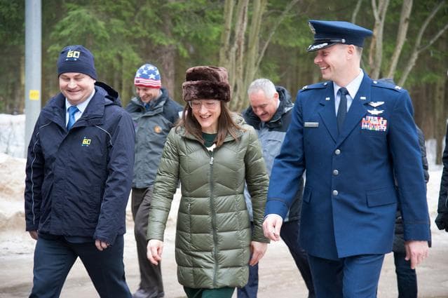 NASA image: At the Gagarin Cosmonaut Training Center in Star City, Russia, Expedition 59 crewmembers Alexey Ovchinin of Roscosmos (left), Christina Koch of NASA (center) and Nick Hague of NASA (right) walk to a bus Feb. 26 to take them to their plane for a flight to 