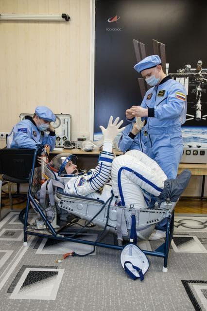 NASA image: jsc2019e009949 = At the Baikonur Cosmodrome in Kazakhstan, Expedition 59 crewmember Nick Hague of NASA undergoes a Sokol launch suit pressure check Feb. 27 during pre-launch training. Hague, Christina Koch of NASA and Alexey Ovchinin of Roscosmos will lau