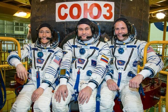 NASA image: jsc2019e009956 - At the Baikonur Cosmodrome in Kazakhstan, Expedition 59 crewmembers Christina Koch of NASA (left), Alexey Ovchinin of Roscosmos (center) and Nick Hague of NASA (right) pose for pictures in front of their Soyuz MS-12 spacecraft Feb. 27 dur