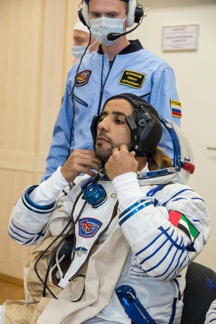 NASA image: jsc2019e052884 - In the Integration Building at the Baikonur Cosmodrome in Kazakhstan, spaceflight participant Hazzaa Ali Almansoori of the United Arab Emirates suits up Sept. 11 for a fit check aboard the Soyuz MS-15 spacecraft. Almansoori, Oleg Skripoch