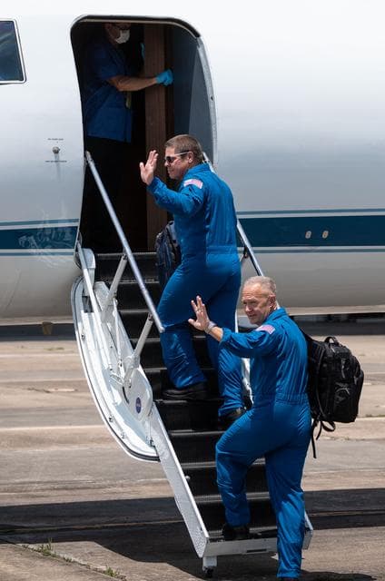 NASA image: jsc2020e023071 - At Ellington Field near NASA’s Johnson Space Center in Houston, astronauts Robert Behnken(left) and Douglas Hurley board the Gulfstream jet that will carry them to the agency’s Kennedy Space Center in Florida on May 20, 2020, in prepa