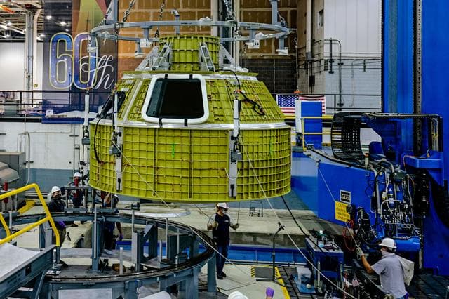 NASA image: Orion crew module pressure vessel lifted from welding tool