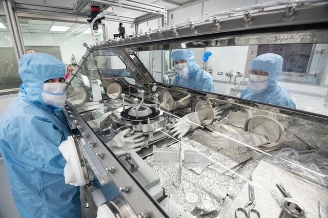 NASA image: OSIRIS Rex curation team pouring the sample from the TAGSAM head