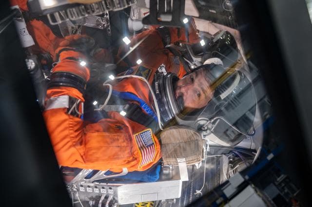 NASA astronauts and Artemis II crew members Reid Wiseman and Victor Glover inside of the Orion spacecraft mockup