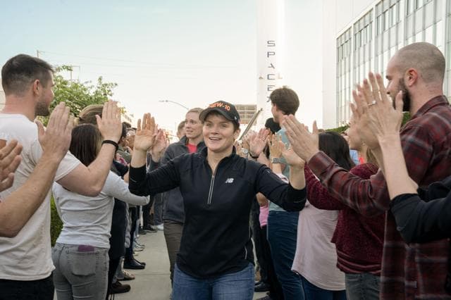 NASA image: jsc2025e011328 - NASA astronaut and commander of NASA's SpaceX Crew-10 mission Anne McClain smiles and high fives SpaceX employees during a sendoff at the company’s facility in Hawthorne, California. Credit: SpaceX