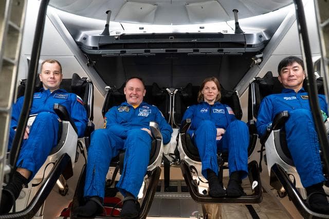 NASA image: NASA's SpaceX Crew-11 members pose for a portrait inside a Dragon training crew spacecraft
