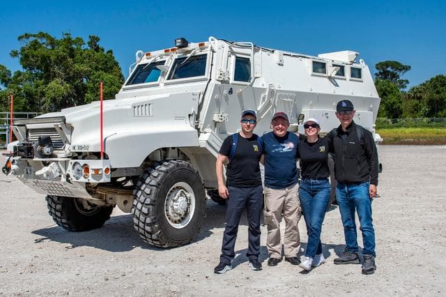NASA image: NASA's SpaceX Crew-11 members pose for a portrait by an emergency egress vehicle