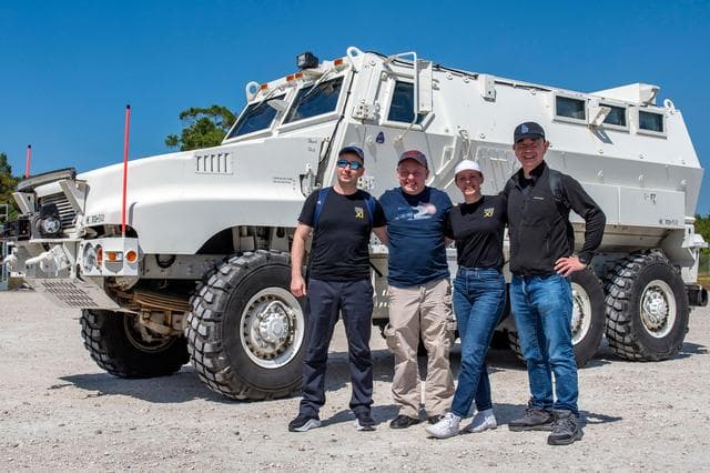 NASA image: NASA's SpaceX Crew-11 members pose for a portrait by an emergency egress vehicle