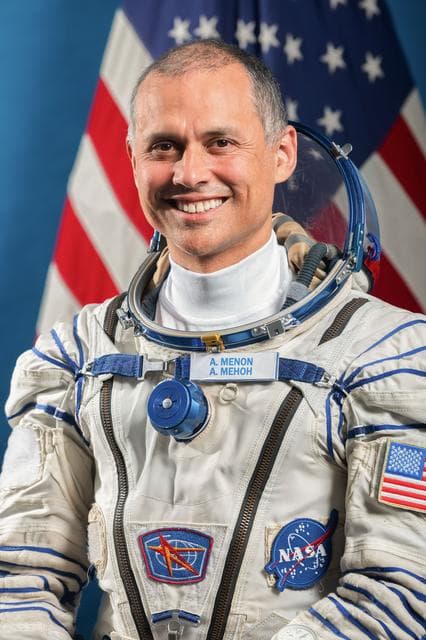 NASA image: NASA astronaut Flight Engineer Anil Menon poses for a portrait in his Sokol launch and entry suit