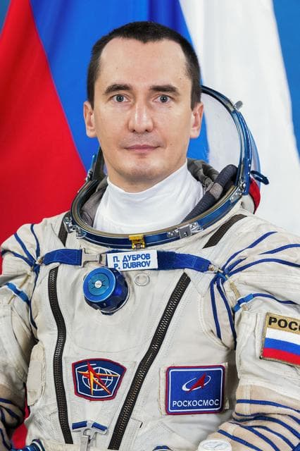 NASA image: Soyuz MS-28 Backup Commander Pyotr Dubrov poses for a portrait in his Sokol launch and entry suit