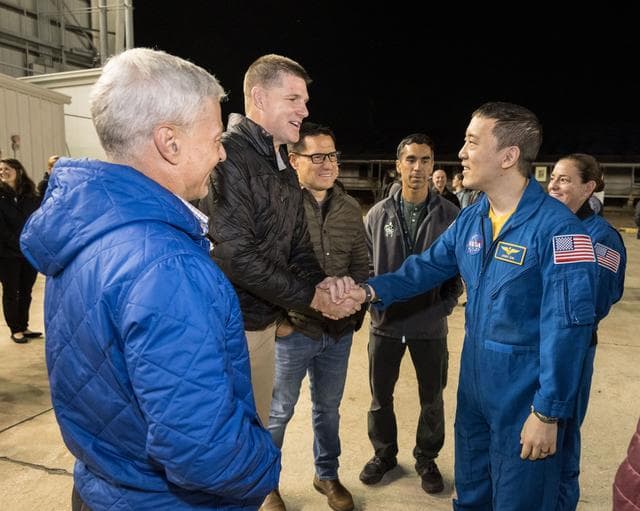 NASA image: NASA astronaut Jonny Kim shakes the hand of Artemis II crew member Jeremy Hansen