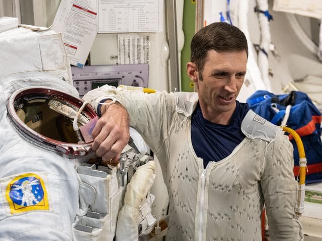 NASA image: CSA (Canadian Space Agency) astronaut Josh Kutryk practices suiting up in a spacesuit