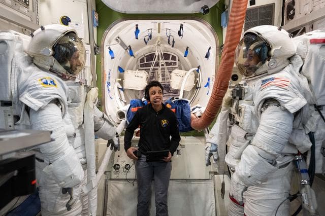NASA image: Astronaut Jessica Watkins assists astronauts Josh Kutryk and Luke Delaney as they practice suiting up