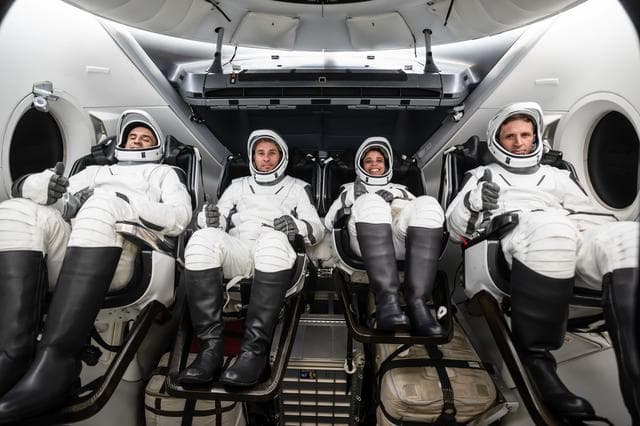 NASA image: The SpaceX Crew-13 members are seated inside a mockup Dragon spacecraft