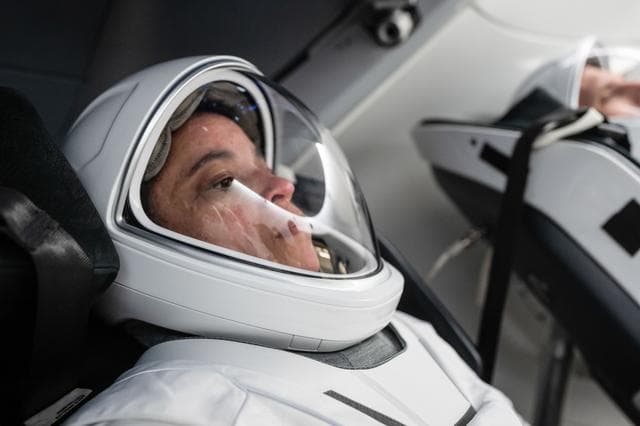 NASA image: NASA astronaut Jessica Watkins is seated inside a mockup Dragon spacecraft