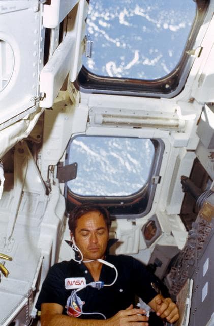 NASA image: Pilot Crippen eats rehydrated food at aft flight deck onorbit station