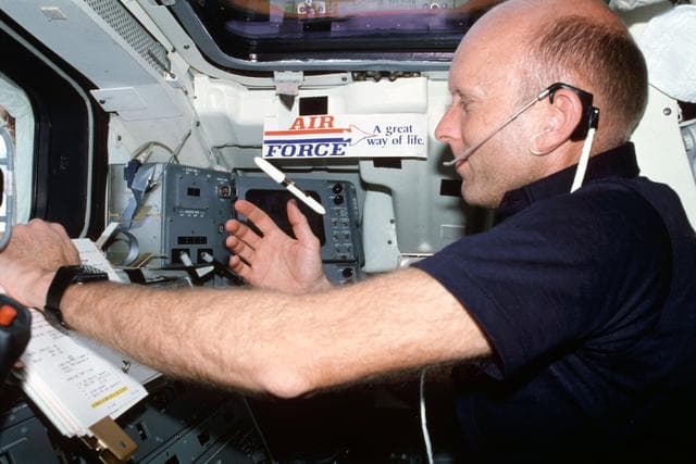 NASA image: Pilot Fullerton reviews checklist on Aft Flight Deck Onorbit Station