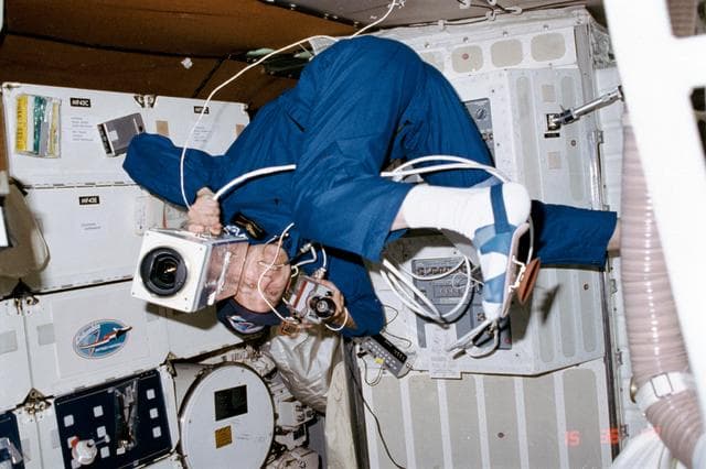 NASA image: Commander Mattingly uses 16mm DAC and FS crew cabin camera on middeck