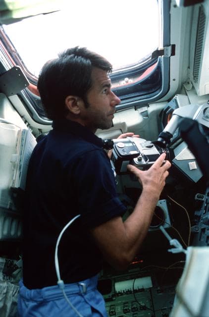 NASA image: Mission Specialist (MS) Lenoir at aft flight deck with HASSELBLAD camera