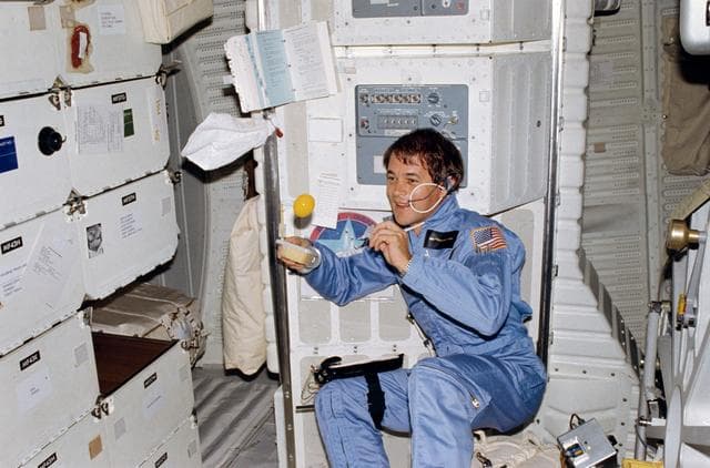 NASA image: Mission Specialist (MS) Allen experiments with beverage on middeck