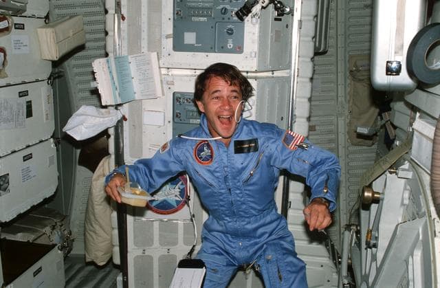 NASA image: Mission Specialist (MS) Allen experiments with beverage on middeck
