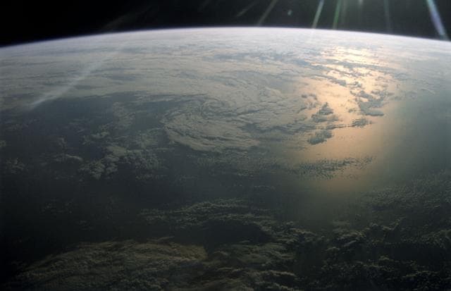 NASA image: Earth Observation of sun-glinted ocean and clouds