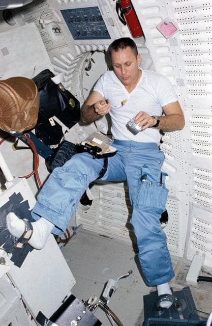NASA image: Pilot Overmyer eats on middeck