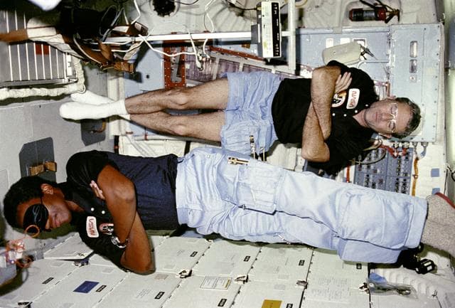 NASA image: Commander Truly and Mission Specialist (MS) Bluford sleep on middeck