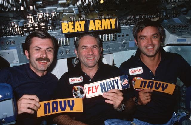NASA image: U.S. Navy crew members display decals on forward flight deck