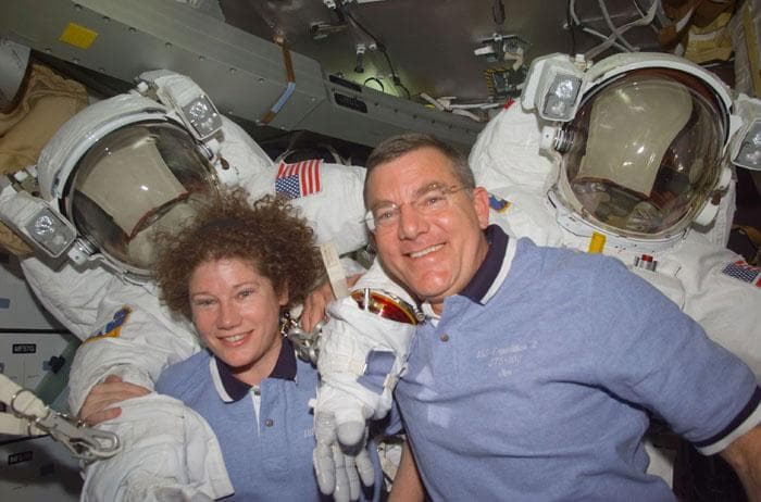 NASA image: Voss and Helms with their EMU suits in the middeck