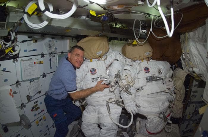 NASA image: Voss poses for a photo with his EMU suit
