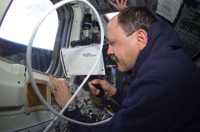 NASA image: Usachev uses a laser range finder during rendezvous ops