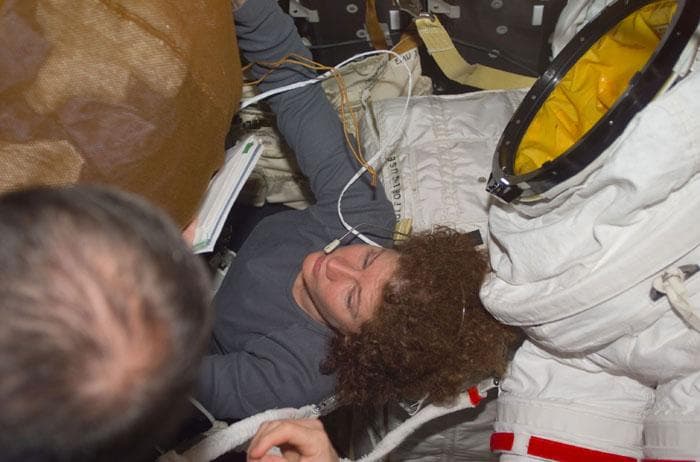 NASA image: Helms in the middle of a crowded middeck