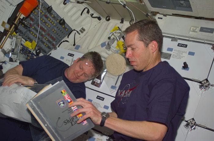 NASA image: Wetherbee with the ship's log in the middeck