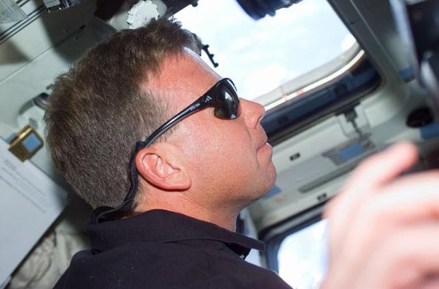 NASA image: CDR Lindsey on aft flight deck wearing sunglasses