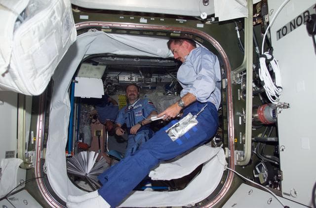 NASA image: Reilly in Quest airlock hatch