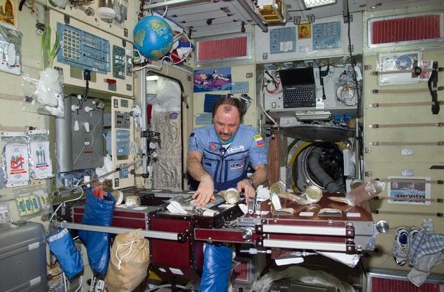 NASA image: Usachev at ward room table in Service Module
