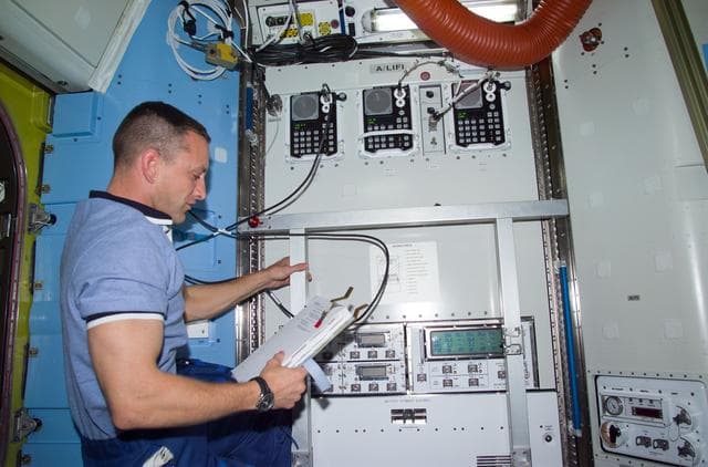NASA image: PLT Horbaugh at control panel in Quest airlock