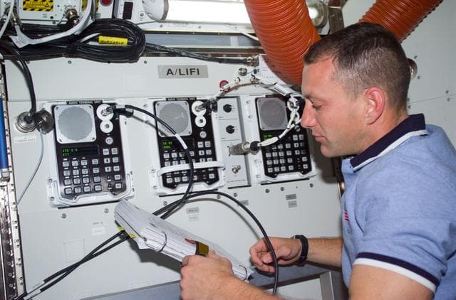 NASA image: PLT Horbaugh at control panel in the Airlock Quest
