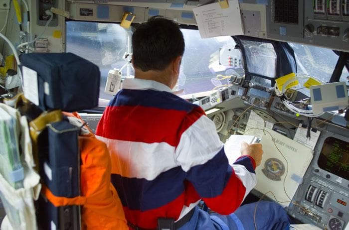 NASA image: Horowitz checks flight notes at the commander's station